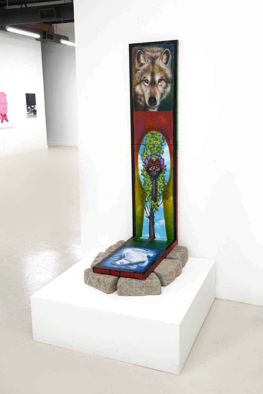 triptych painting positioned on top of a bed of rocks by Mia Scarpa. The artwork represents the tree of life