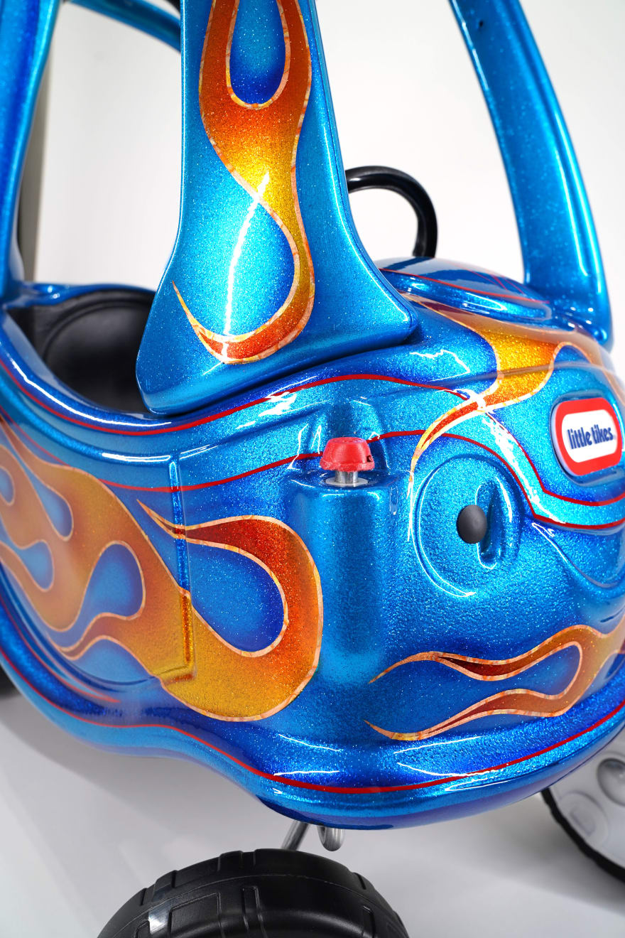 photo of a blue childrens car with painted flames