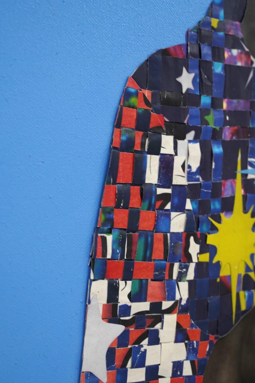 paper collage of a young child on a blue background