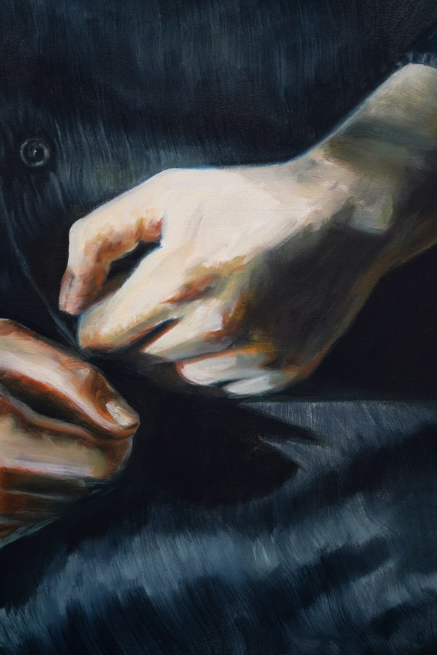 painting of hands sitting in a lap making fists