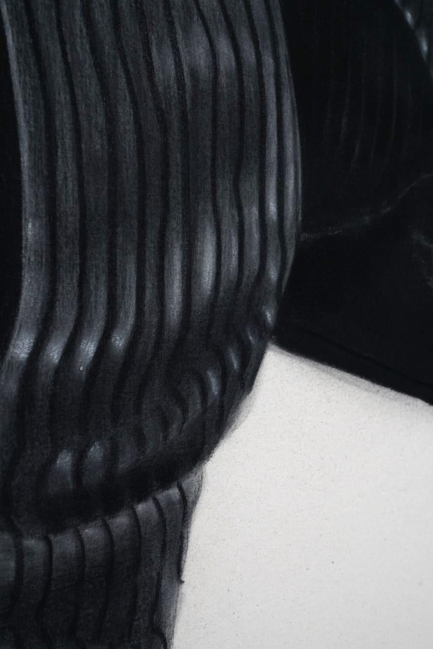 charcoal drawing of a mans shoes with cadillac symbols on them