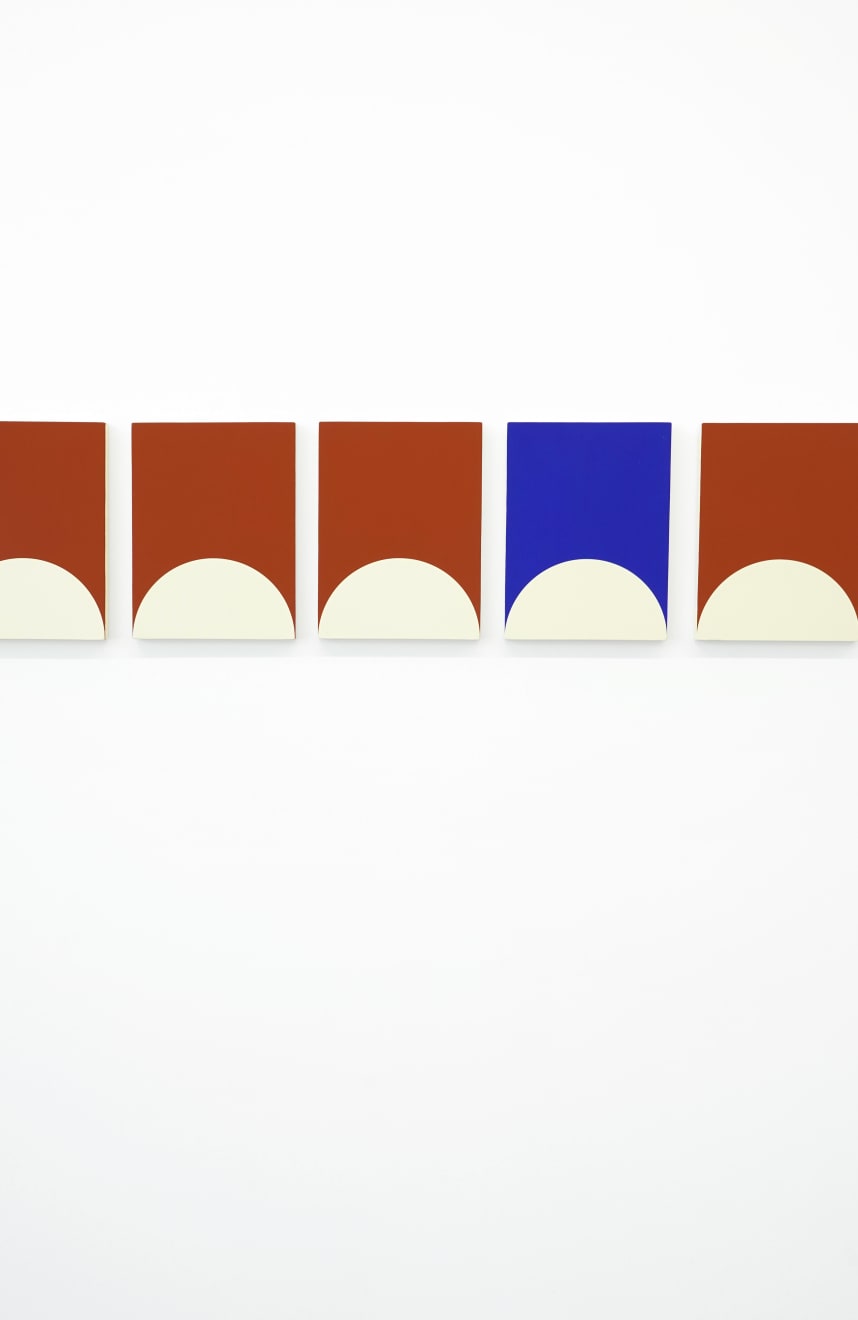 array of of geometrically painted paintings hung in a straight line