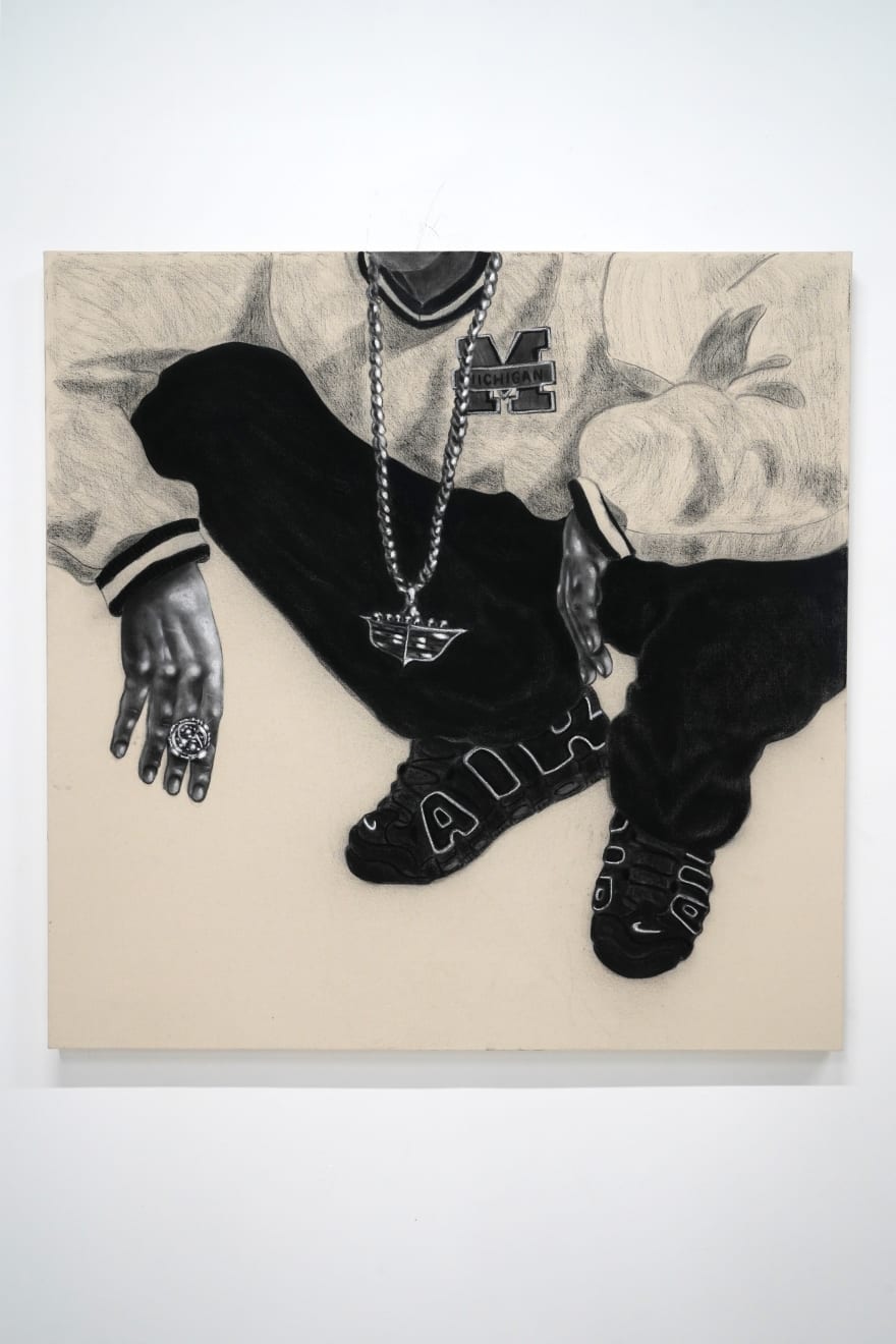 charcoal drawing of a man crouching wearing air jordans and a cadillac symbol necklace