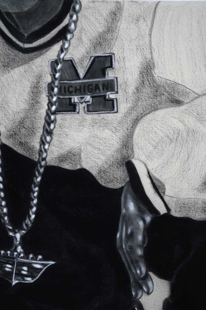 charcoal drawing of a man crouching wearing air jordans and a cadillac symbol necklace