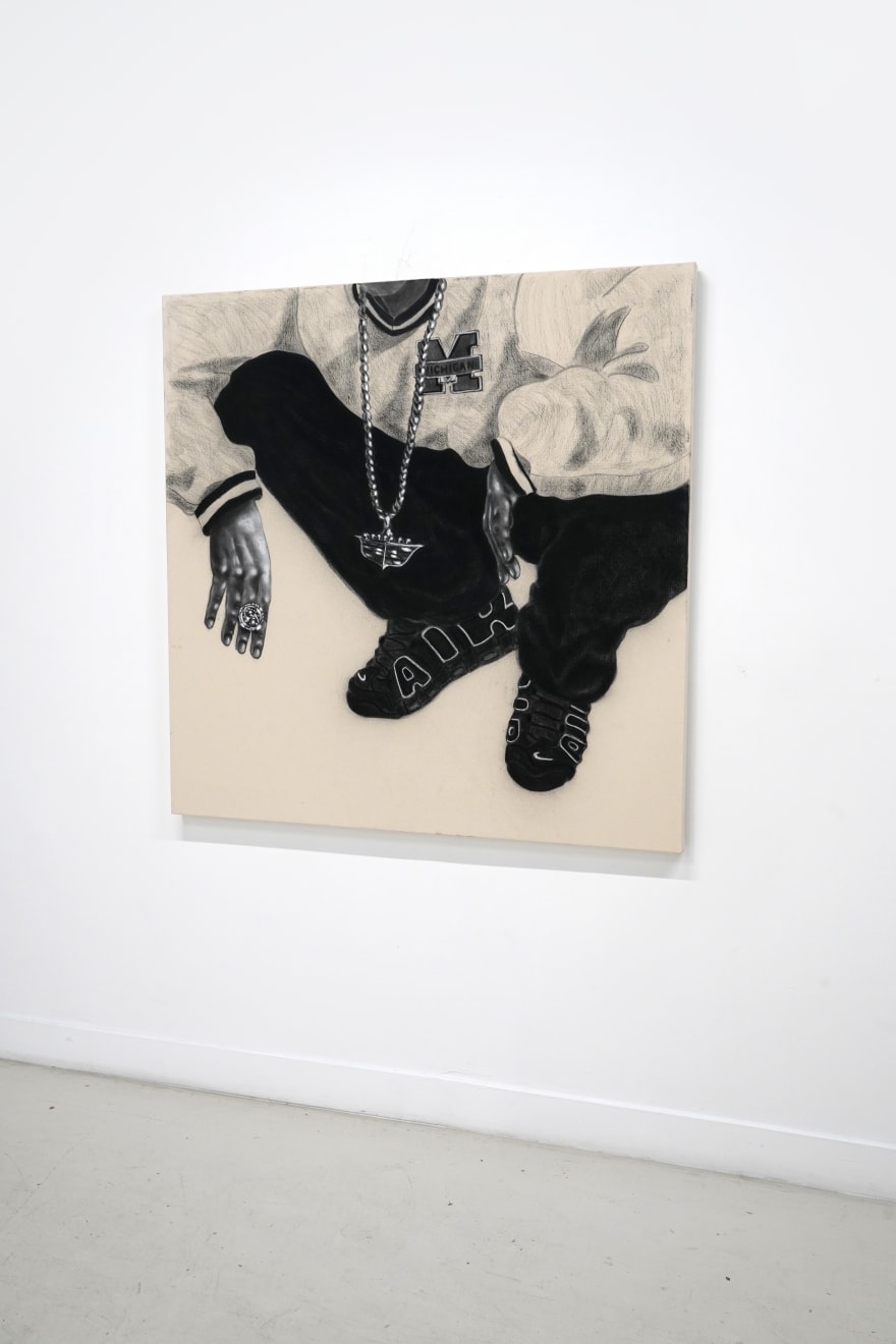 charcoal drawing of a man crouching wearing air jordans and a cadillac symbol necklace