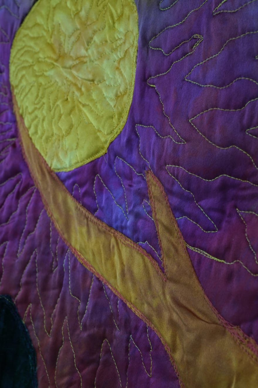 sewn tapestry hanging on wall