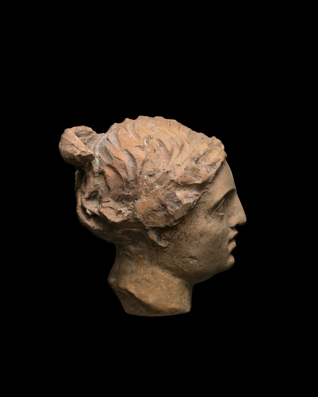Greek, A Greek terracotta head of Aphrodite, Hellenistic, circa 3rd century BC