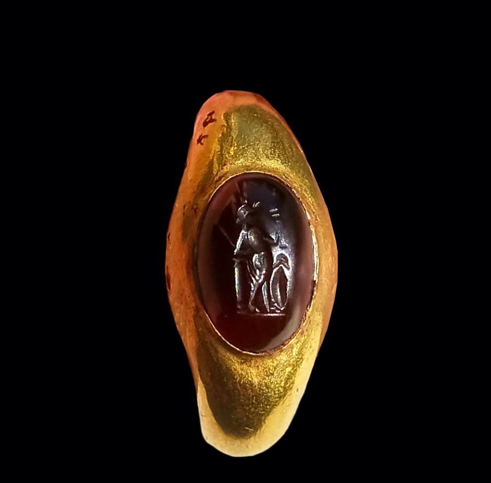 Roman, A large Roman gold ring set with a garnet intaglio of a warrior, Circa 3rd - 4th century AD
