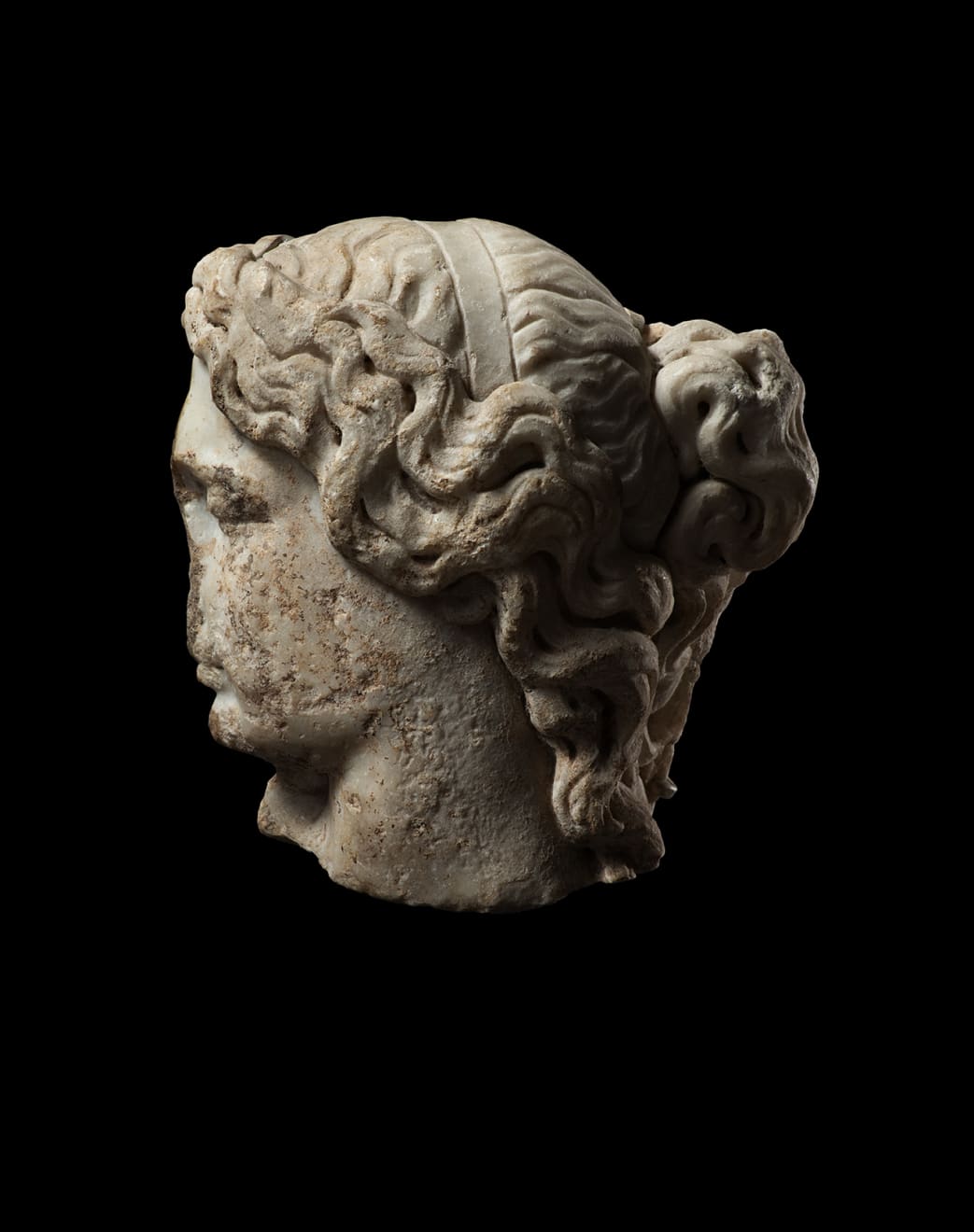 Roman, A Roman marble fragmentary head of a sleeping woman, circa 2nd century AD