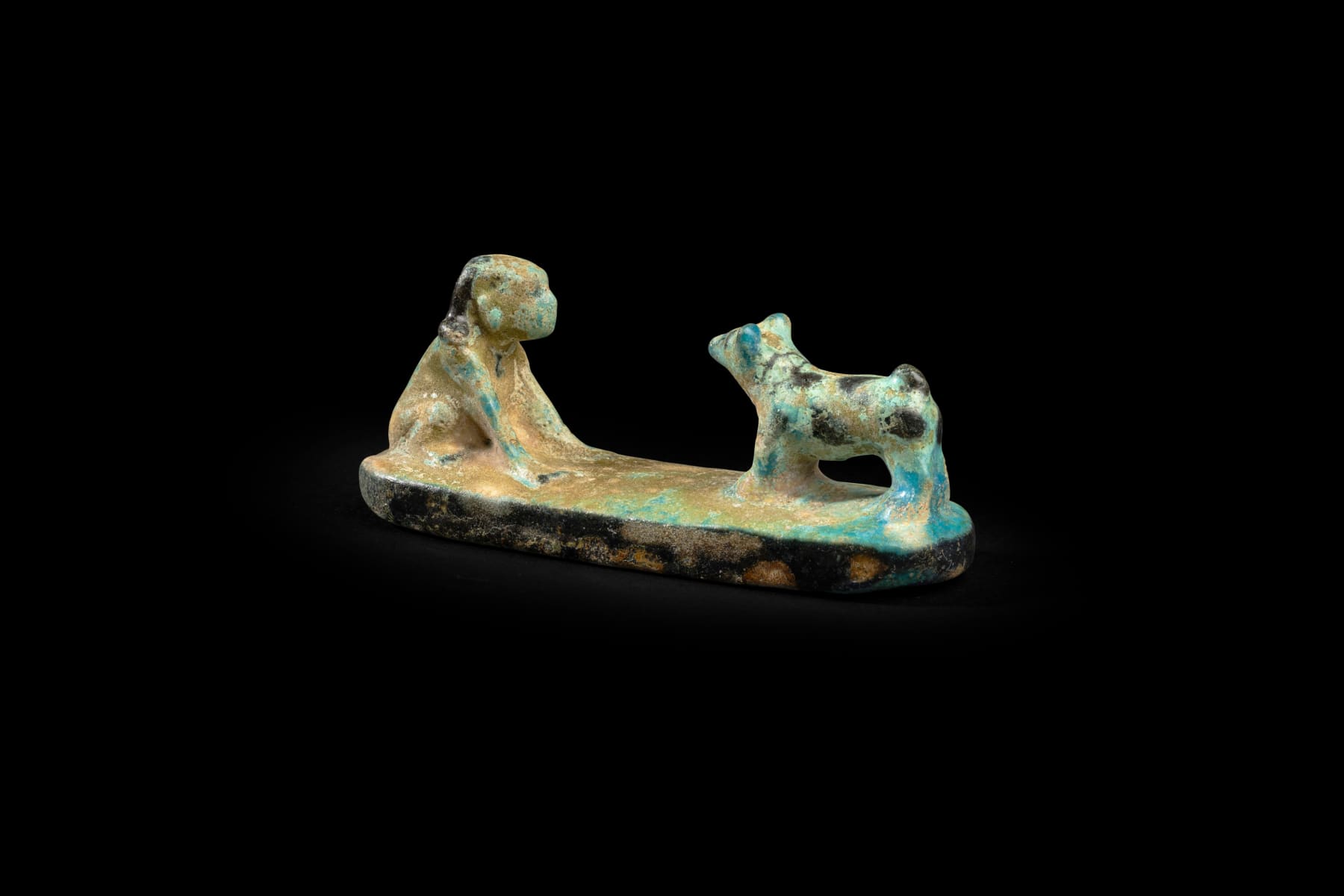 Egyptian, An Egyptian faience group of a boy with a dog, Middle Kingdom, 12th Dynasty, circa 1991 - 1783 BC