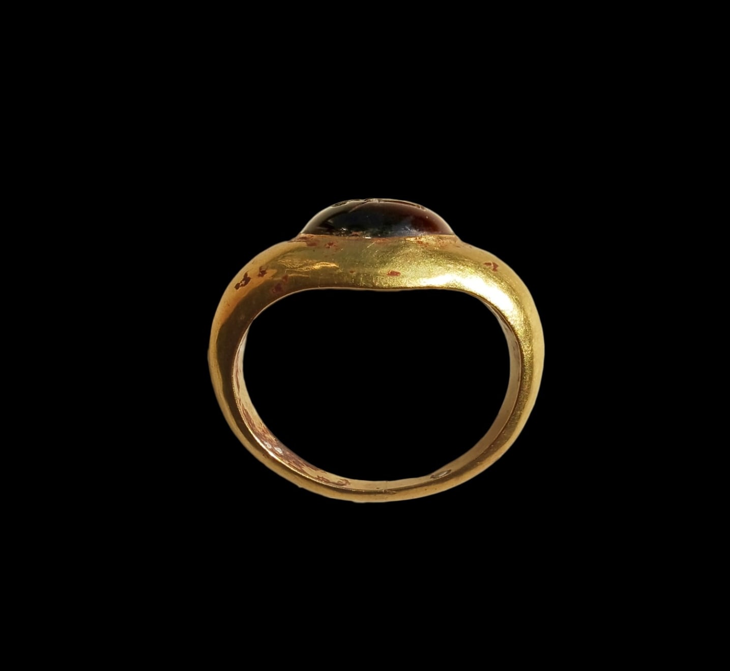 Roman, A large Roman gold ring set with a garnet intaglio of a warrior, Circa 3rd - 4th century AD