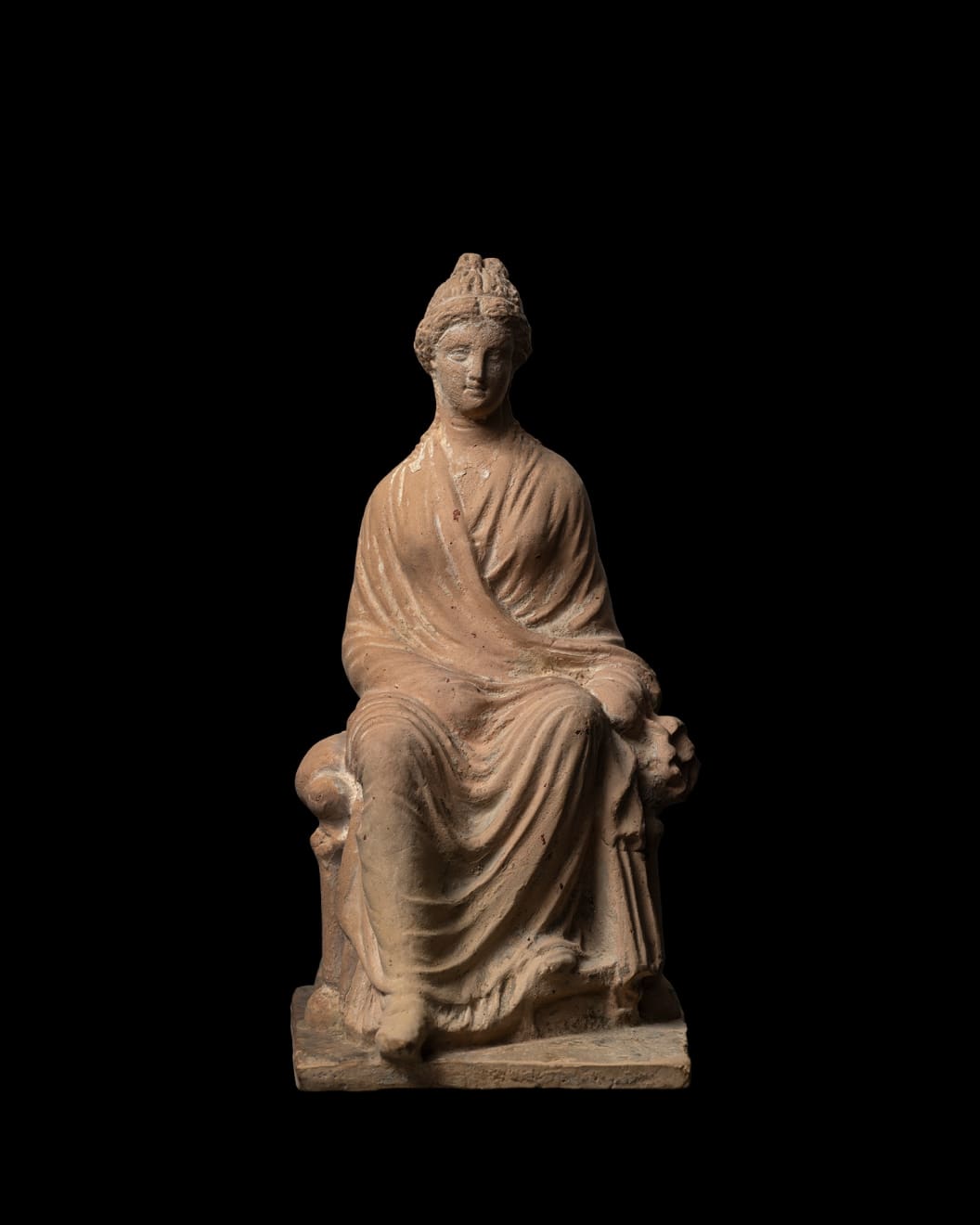 Greek, A Greek terracotta seated female figure, Hellenistic, circa 3rd century BC