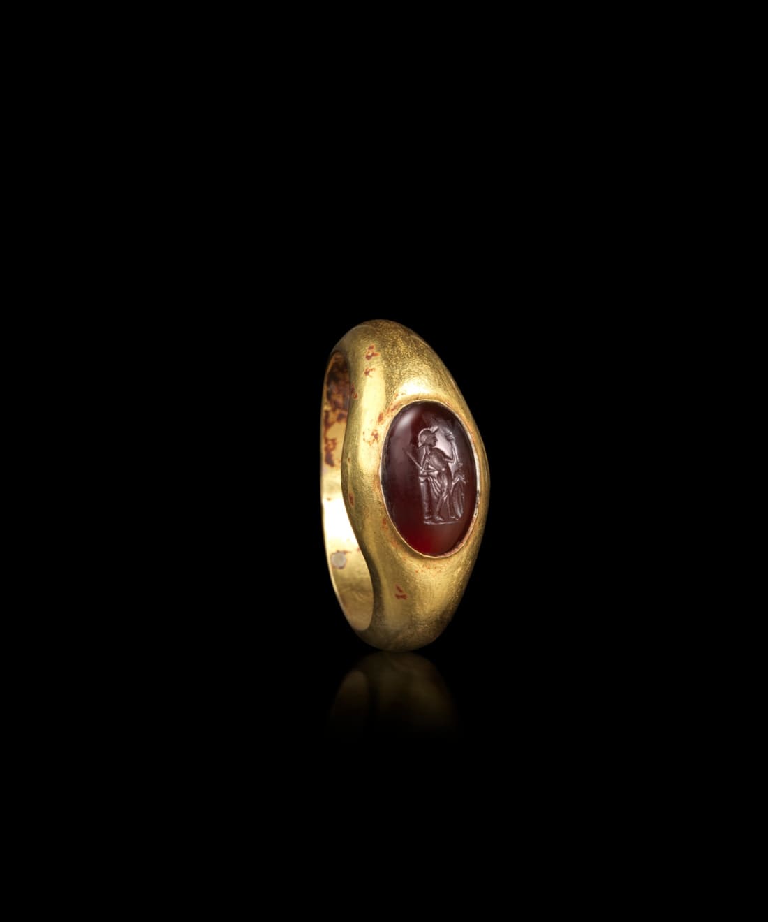Roman, A large Roman gold ring set with a garnet intaglio of a warrior, Circa 3rd - 4th century AD