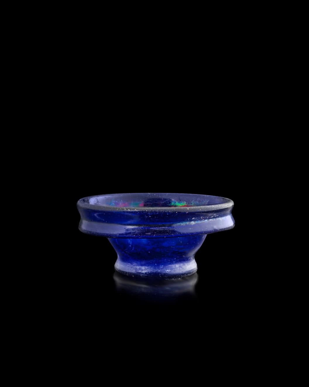 Roman, A small Roman cobalt blue glass acetabulum cup, Eastern Mediterranean or Italy, circa 1st century AD