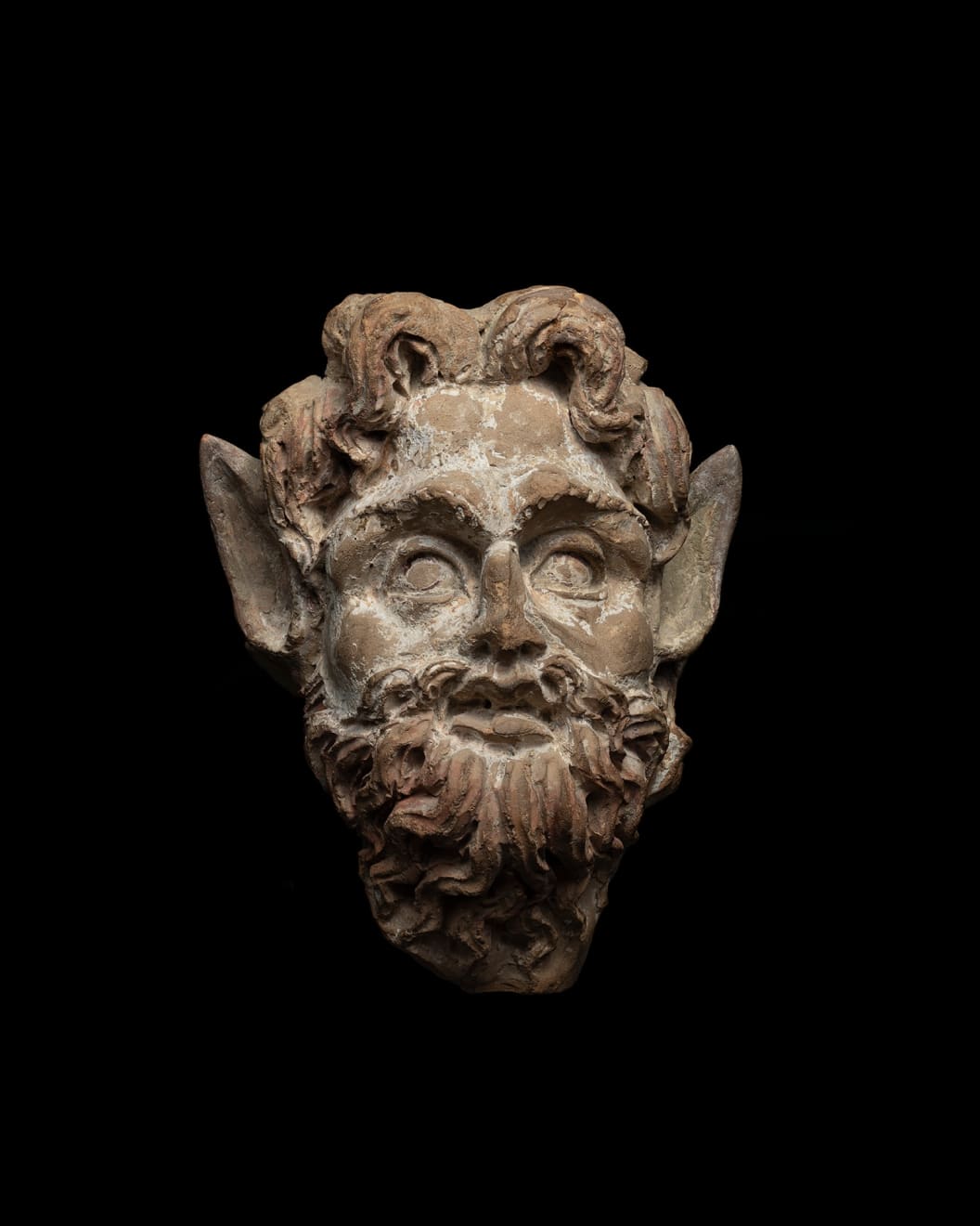 Greek, A Greek terracotta head of Pan, Hellenistic, circa 3rd century BC