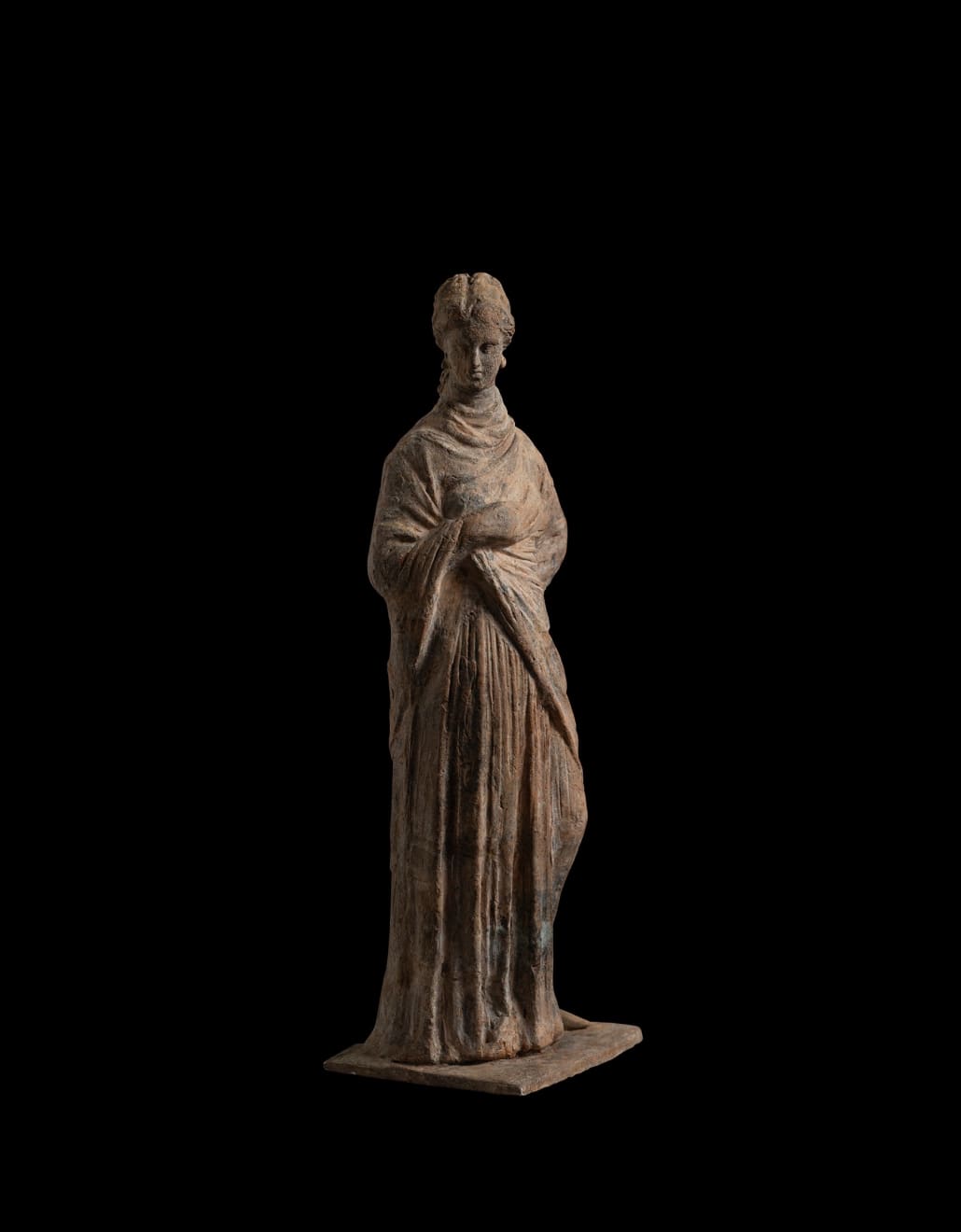 Greek, A Greek terracotta draped female figure, circa 4th - 3rd century BC