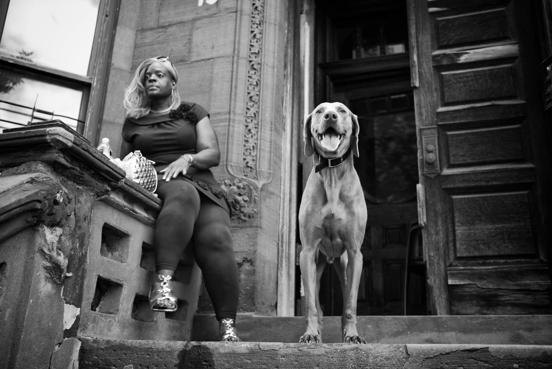 PHIL PENMAN, Woman and her dog, in Harlem, New York, 2015
