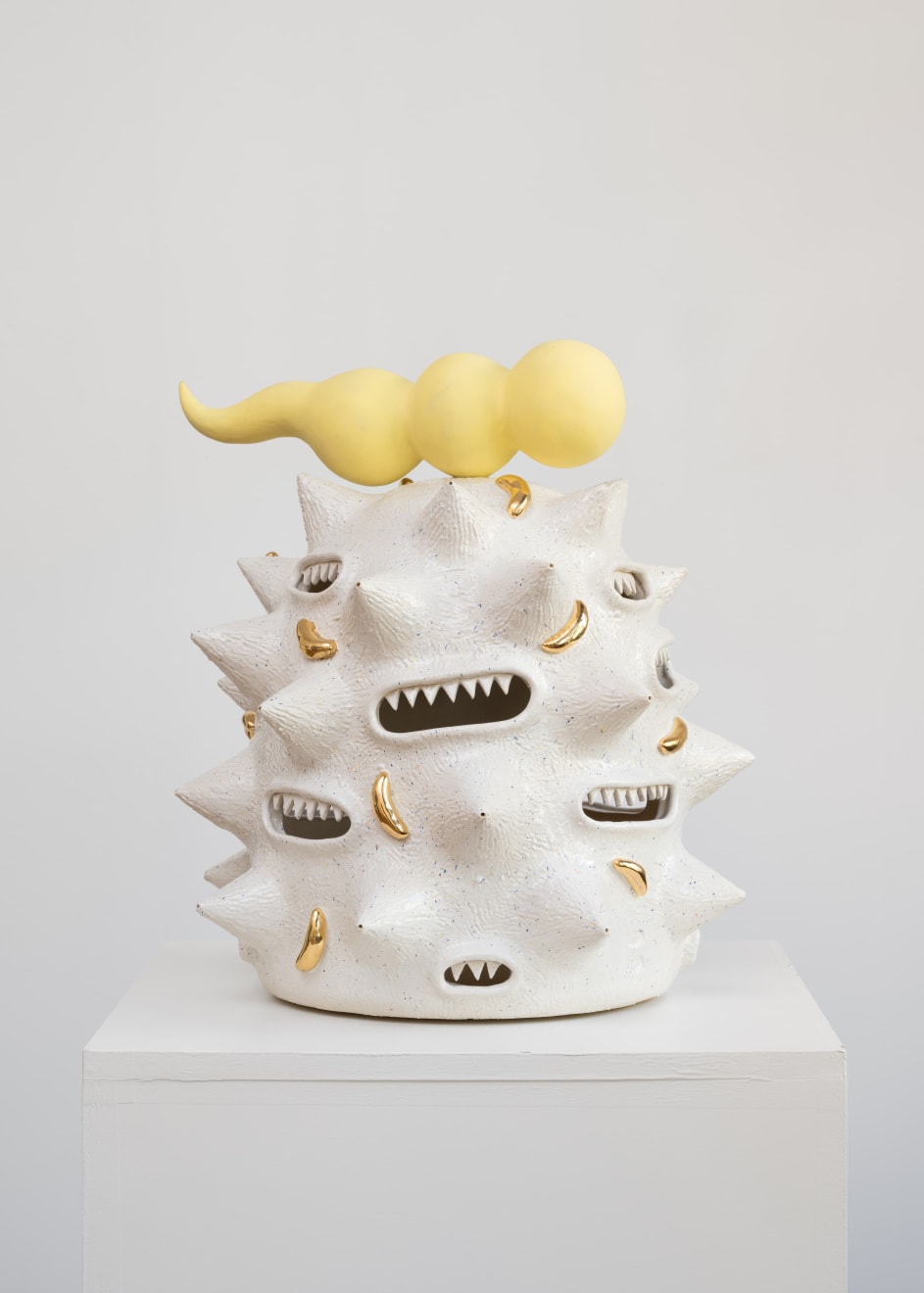 Ceramic sculpture by Kartini Thomas titled Fat white spooter (2025), featuring a spiked organic form topped with a yellow appendage.