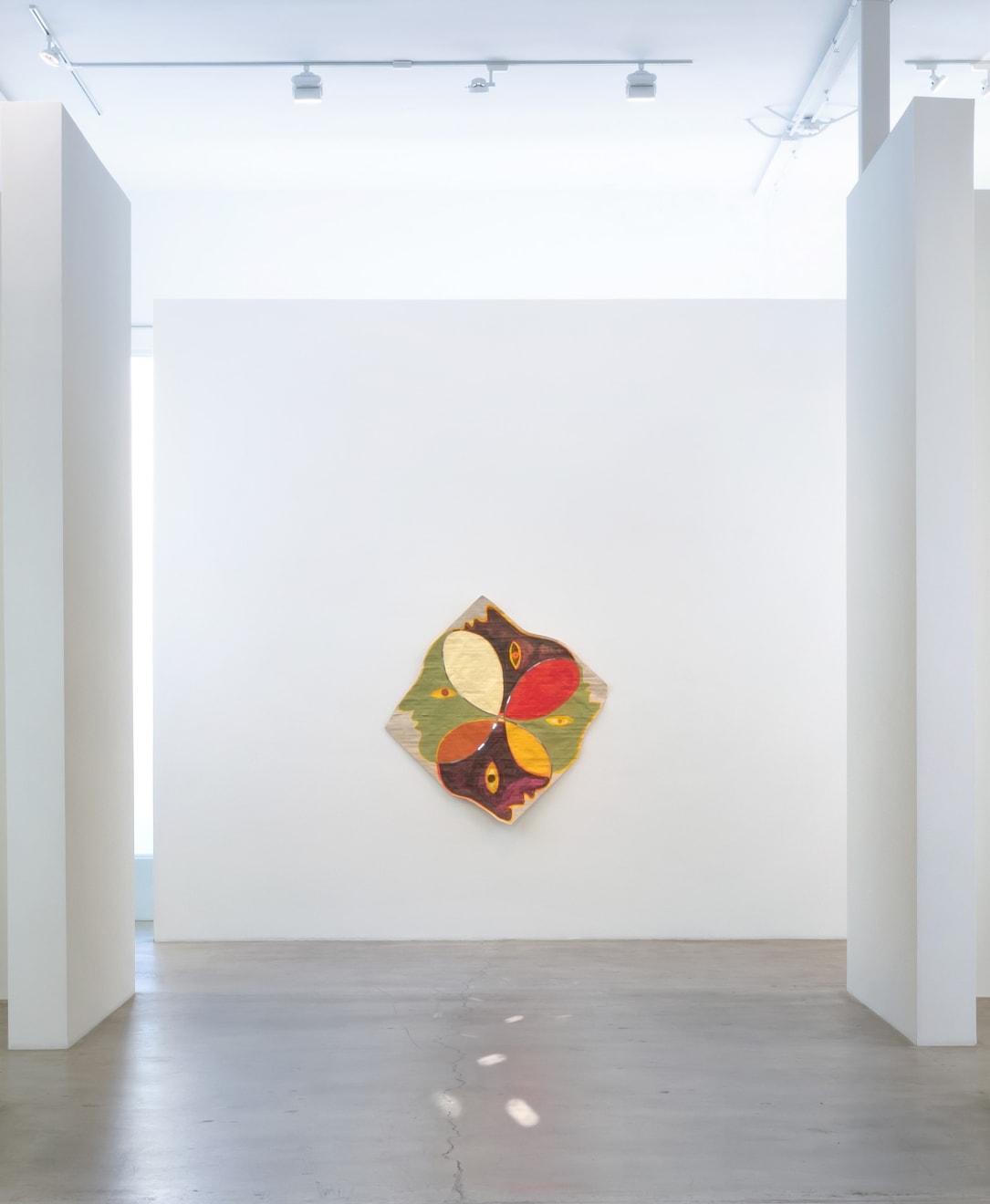 Installation view of Kimia Ferdowsi Kline’s artwork “Four Corners” hanging in a white gallery space with natural light and polished concrete floor