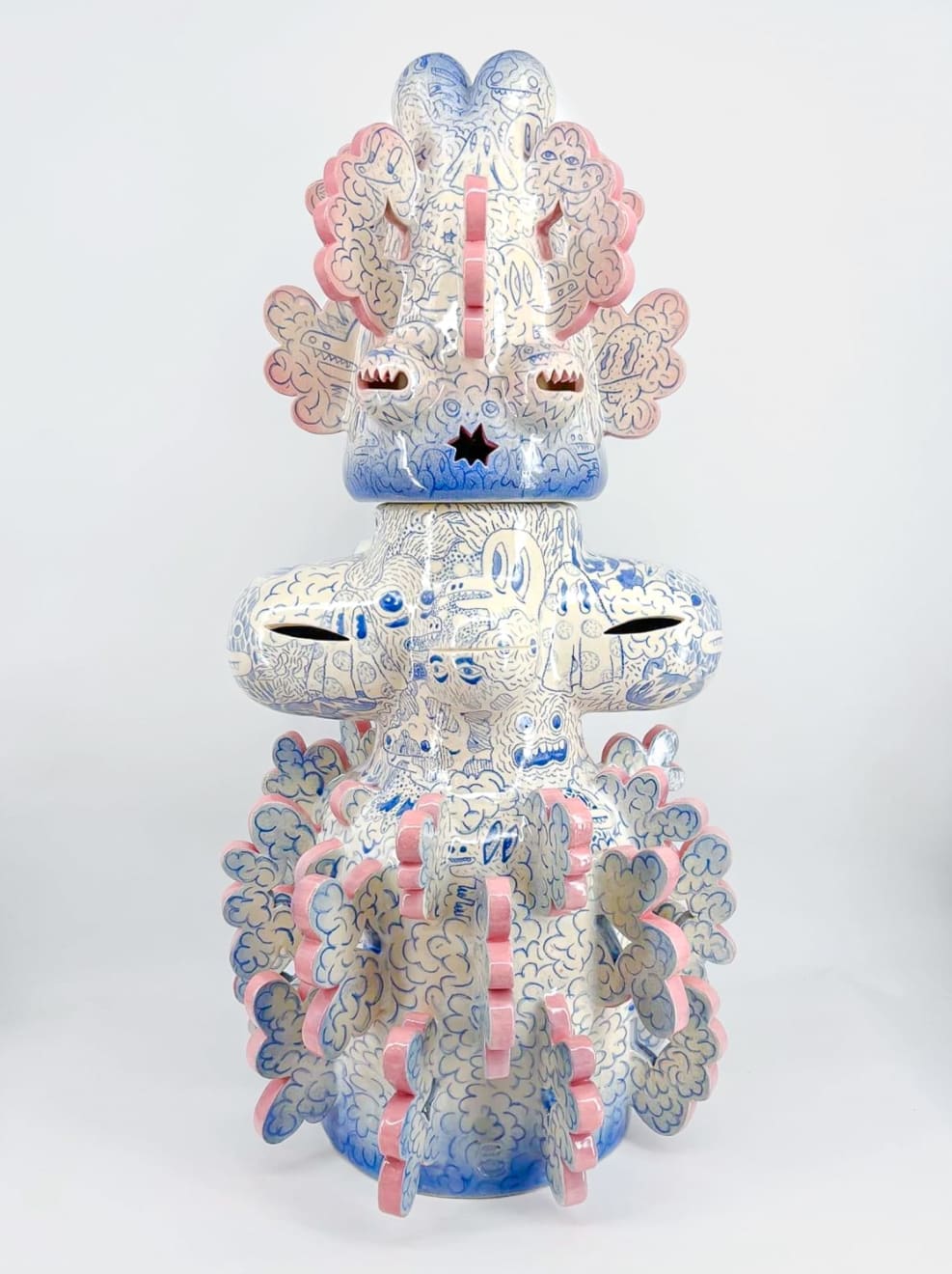 Ceramic sculpture titled “Tattooed Space Monkey” (2024) by Kartini Thomas, biomorphic figure adorned with blue drawings, 90 cm tall.