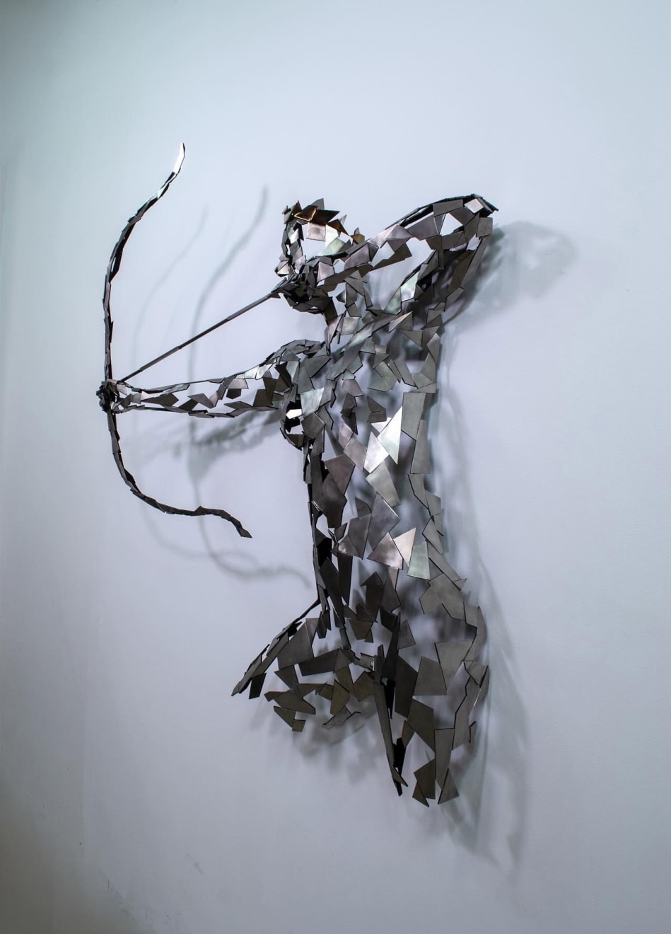 Stainless steel sculpture of a person with a bow and arrow by slate gray gallery artist David Davis