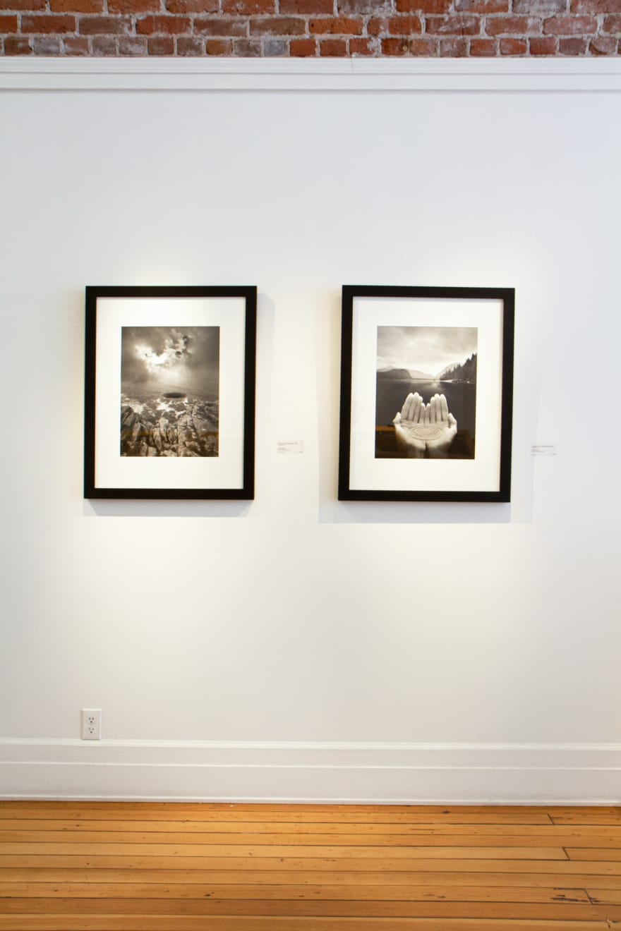 Silver Gelatin Print of hands holding water in front of a mountain landscape by Fringe Gallery artist Jerry Uelsmann
