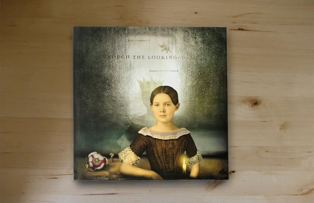 Image of the front cover of slate gray gallery artist Maggie Taylor's book Through the Looking Glass