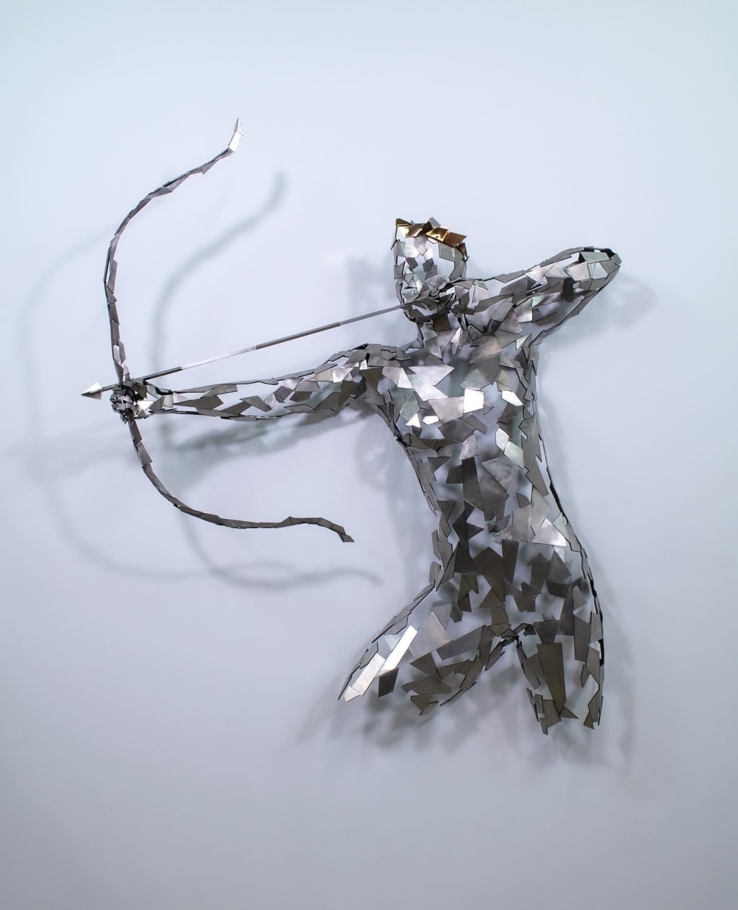 Stainless steel sculpture of a person with a bow and arrow by slate gray gallery artist David Davis
