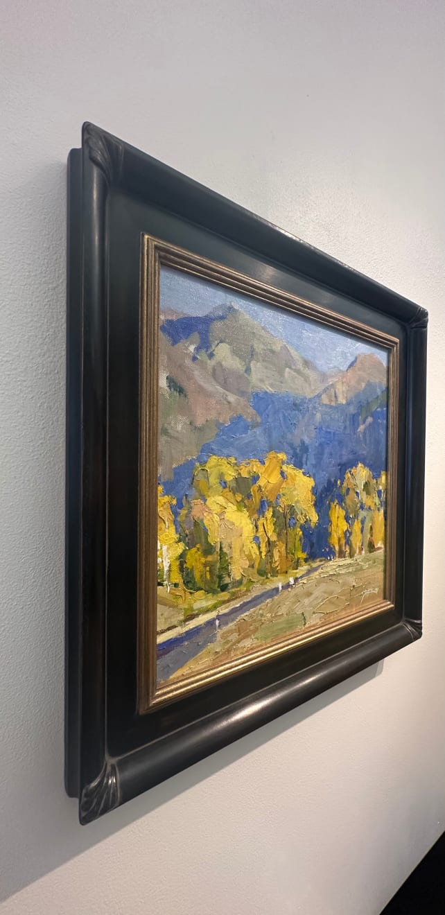 Oil on linen painting in a frame of mountains and yellow trees by slate gray gallery artist Julee Hutchison