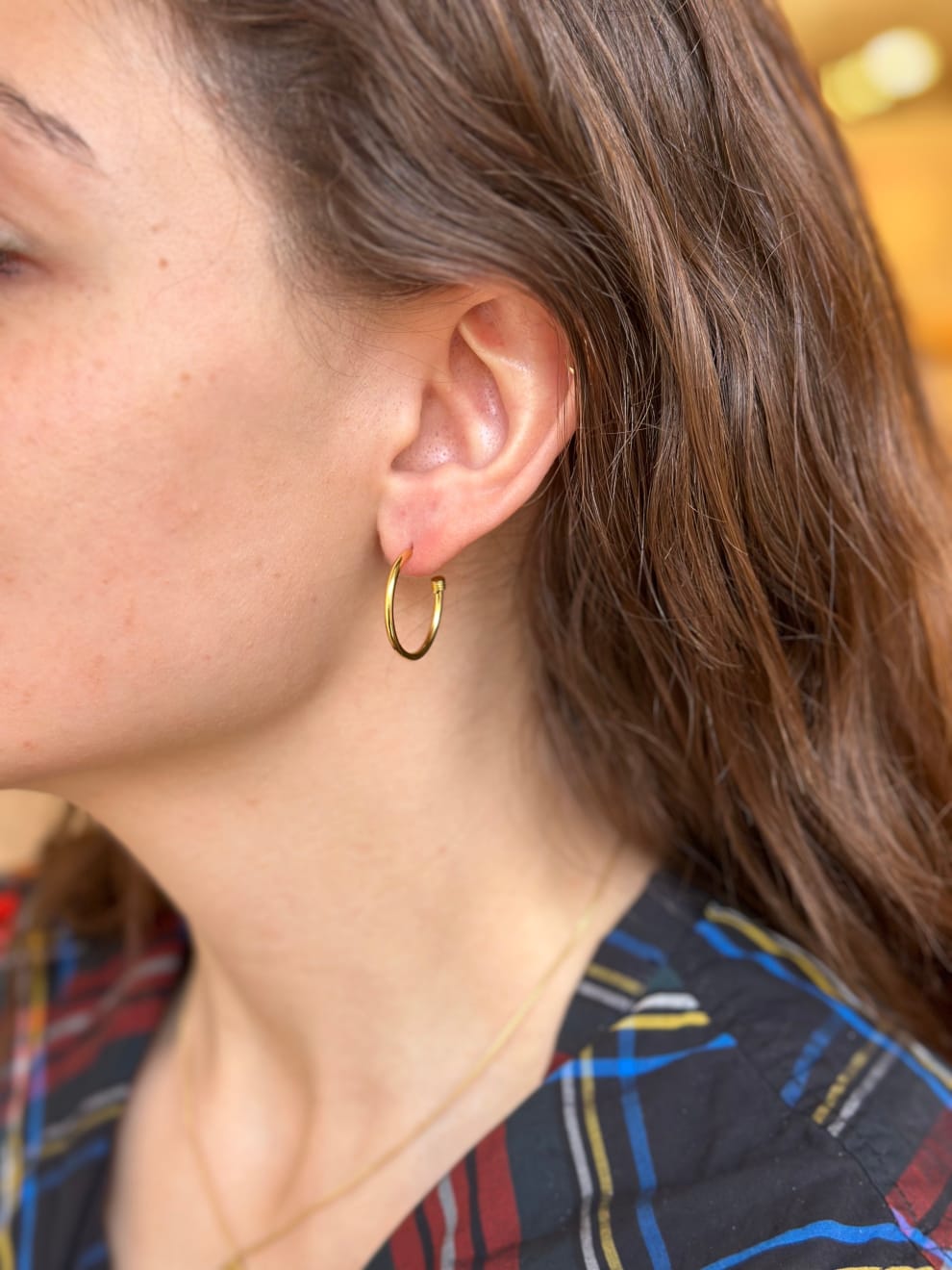 Yellow gold skinny hoops by Fringe Gallery studio jeweler Nanci Modica