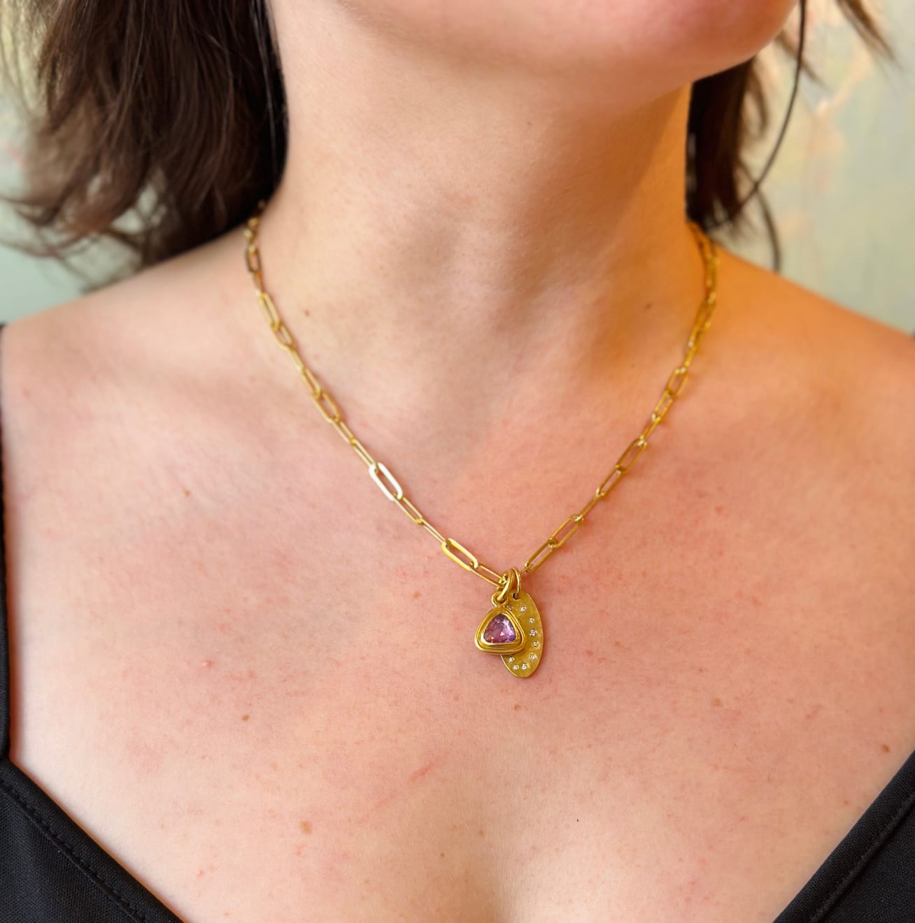 Yellow gold and purple sapphire triangle pendant by Fringe Gallery studio jeweler Nanci Modica