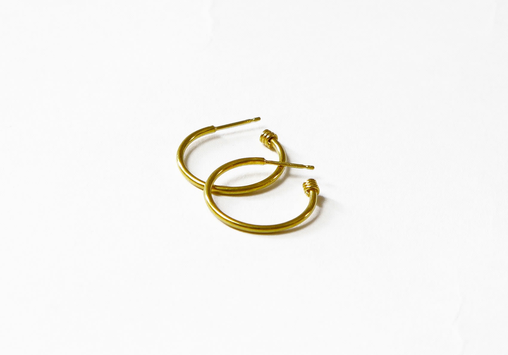 Yellow gold skinny hoops by Fringe Gallery studio jeweler Nanci Modica