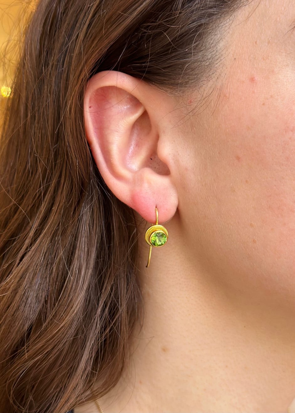 Round faceted green tourmaline and yellow gold earrings by Fringe Gallery studio jeweler Nanci Modica