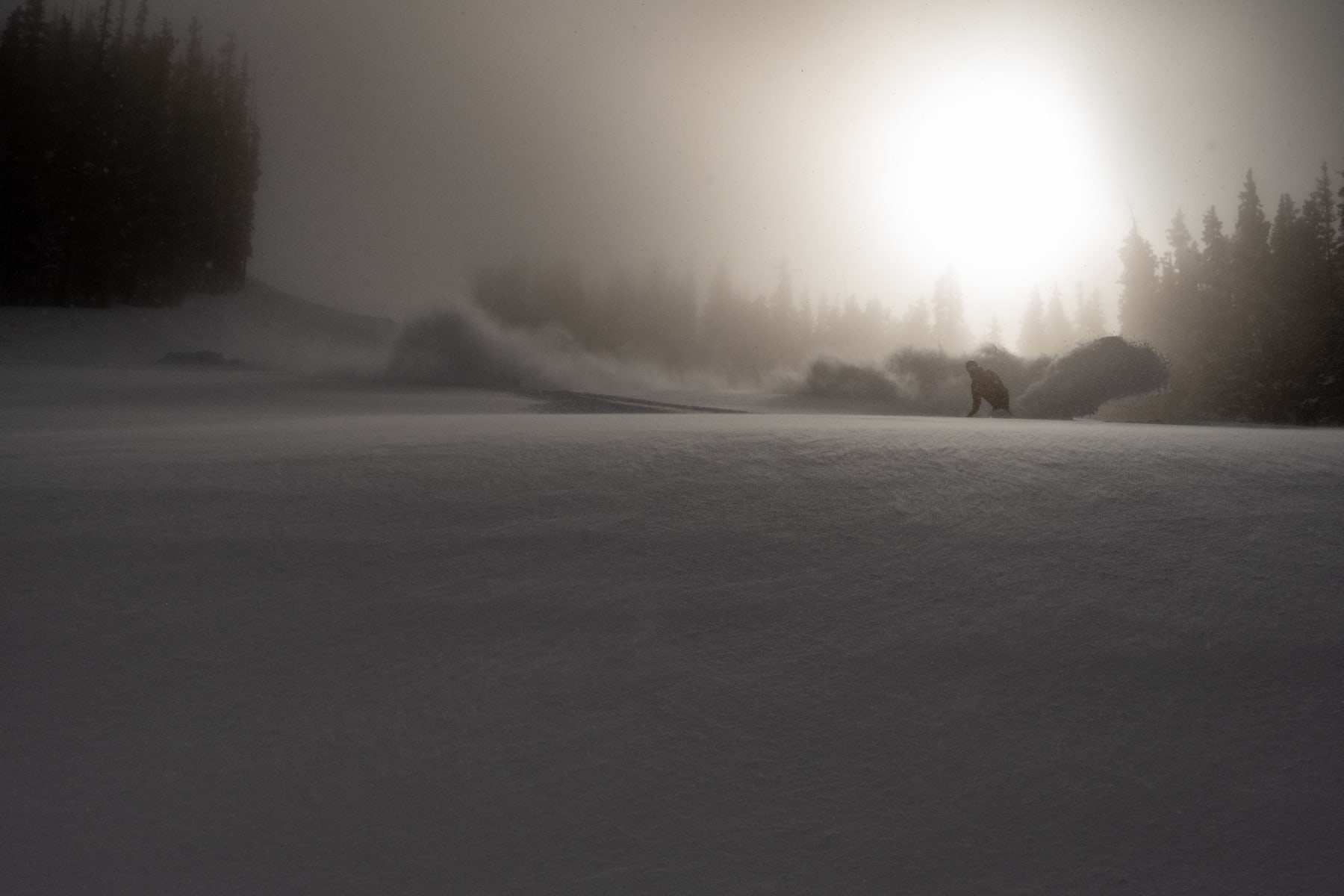 Black and white photo of skier in the distance on a slope by Slate Gray Gallery photographer Brett Schrekengost