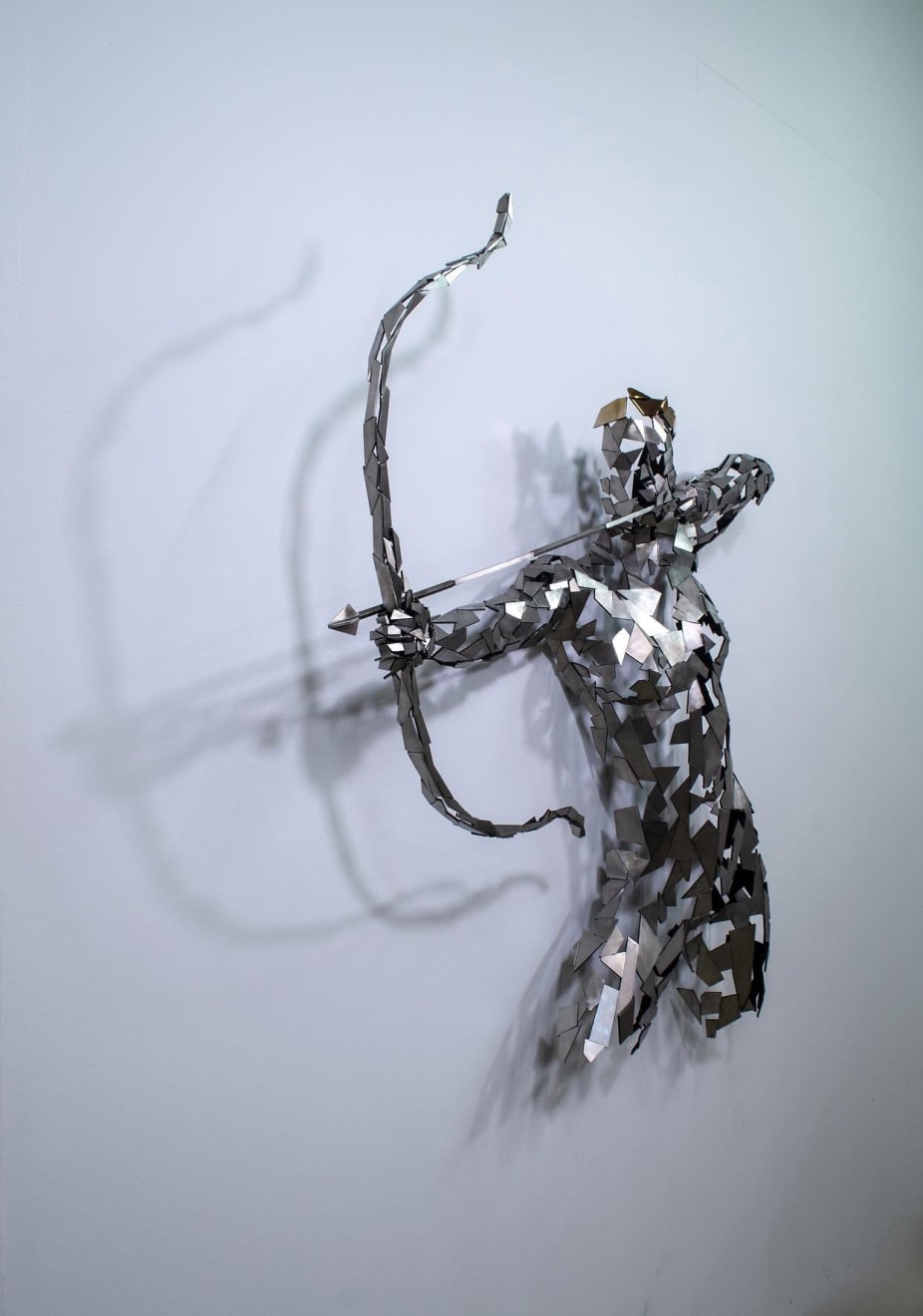 Stainless steel sculpture of a person with a bow and arrow by slate gray gallery artist David Davis