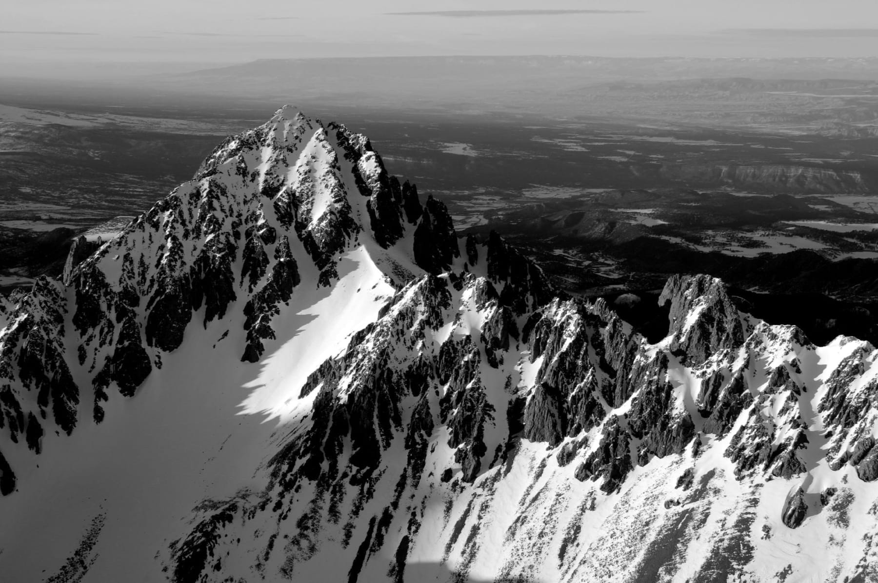Black and white aerial photo of Sneffels Peak in winter by Slate Gray Gallery photographer Brett Schrekengost