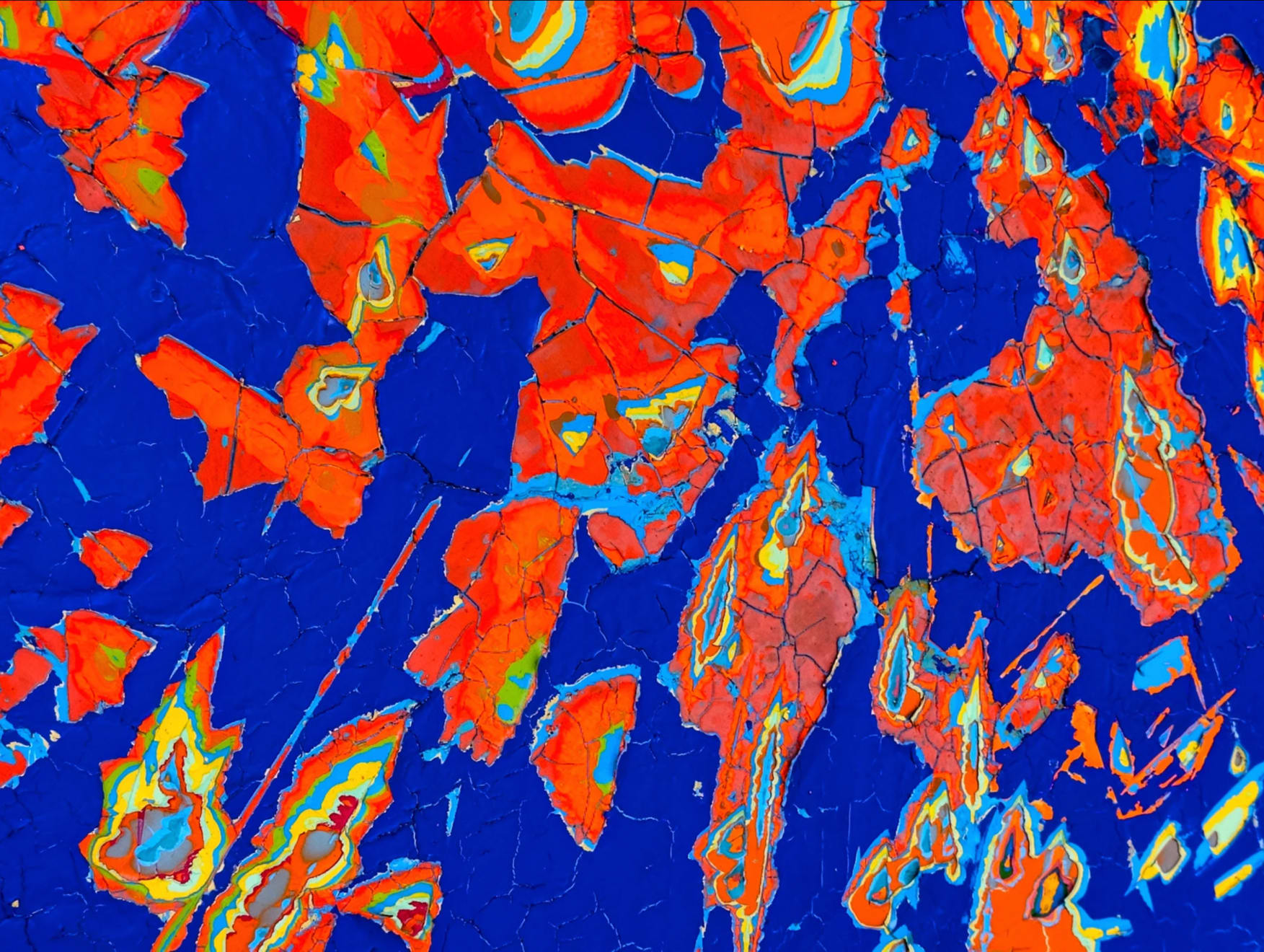 detail view of Jason Hallman excavated painting with blue background with blue background and orange excavated areas