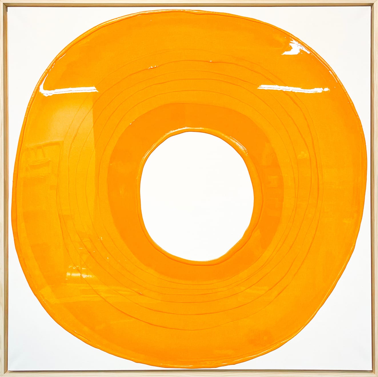 Ted Collier circle series painting with orange circle coated in resin on a white canvas