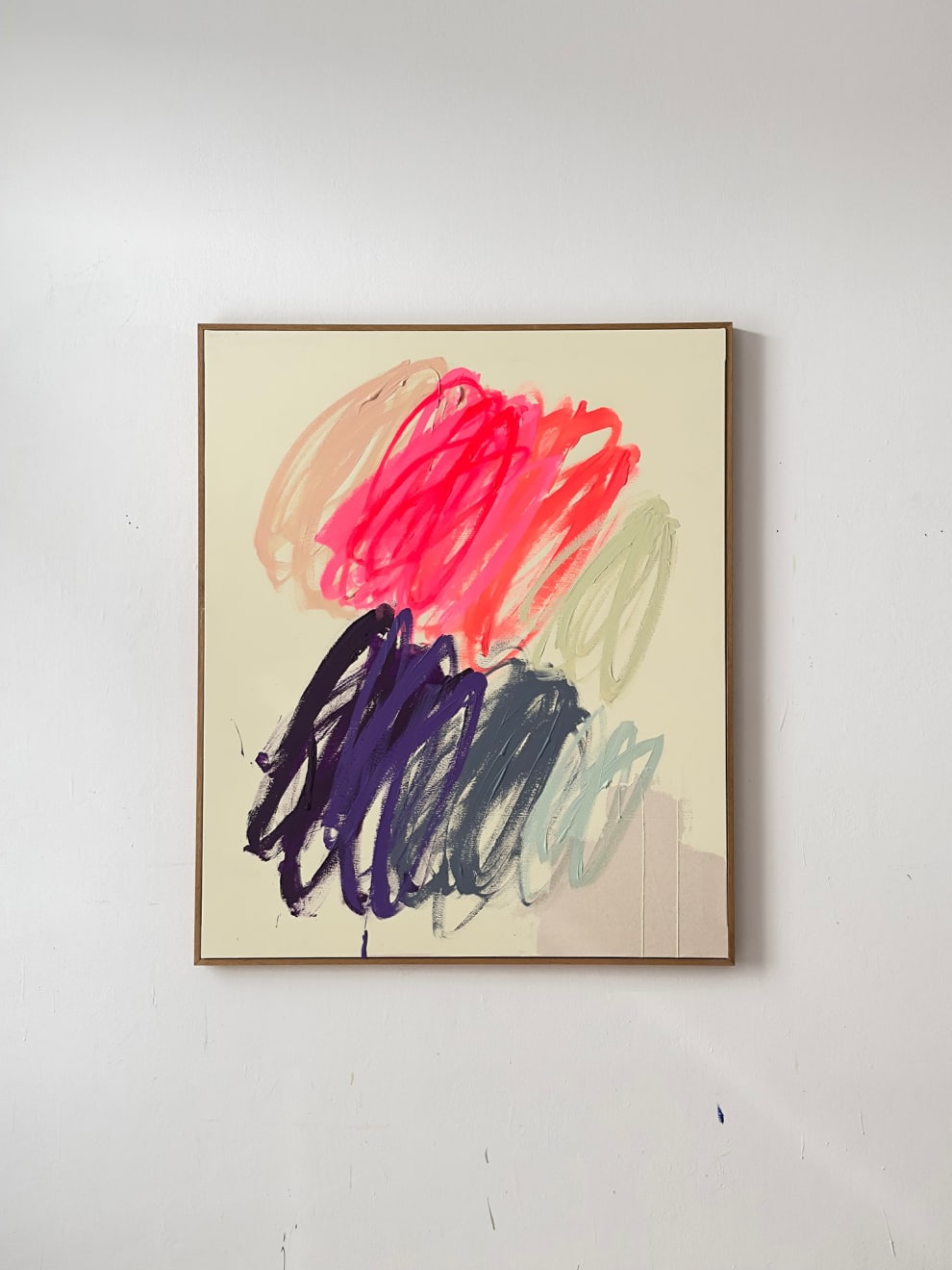 Christina Gschwantner abstract painting with light yellow background with pink and purple scribbles on a wall