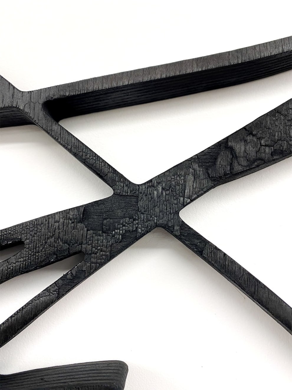 Close up of Black scribble abstract artwork resembling a math equation by Arnaud Vidricaire made of burnt laser cut wood in the form of a diptych