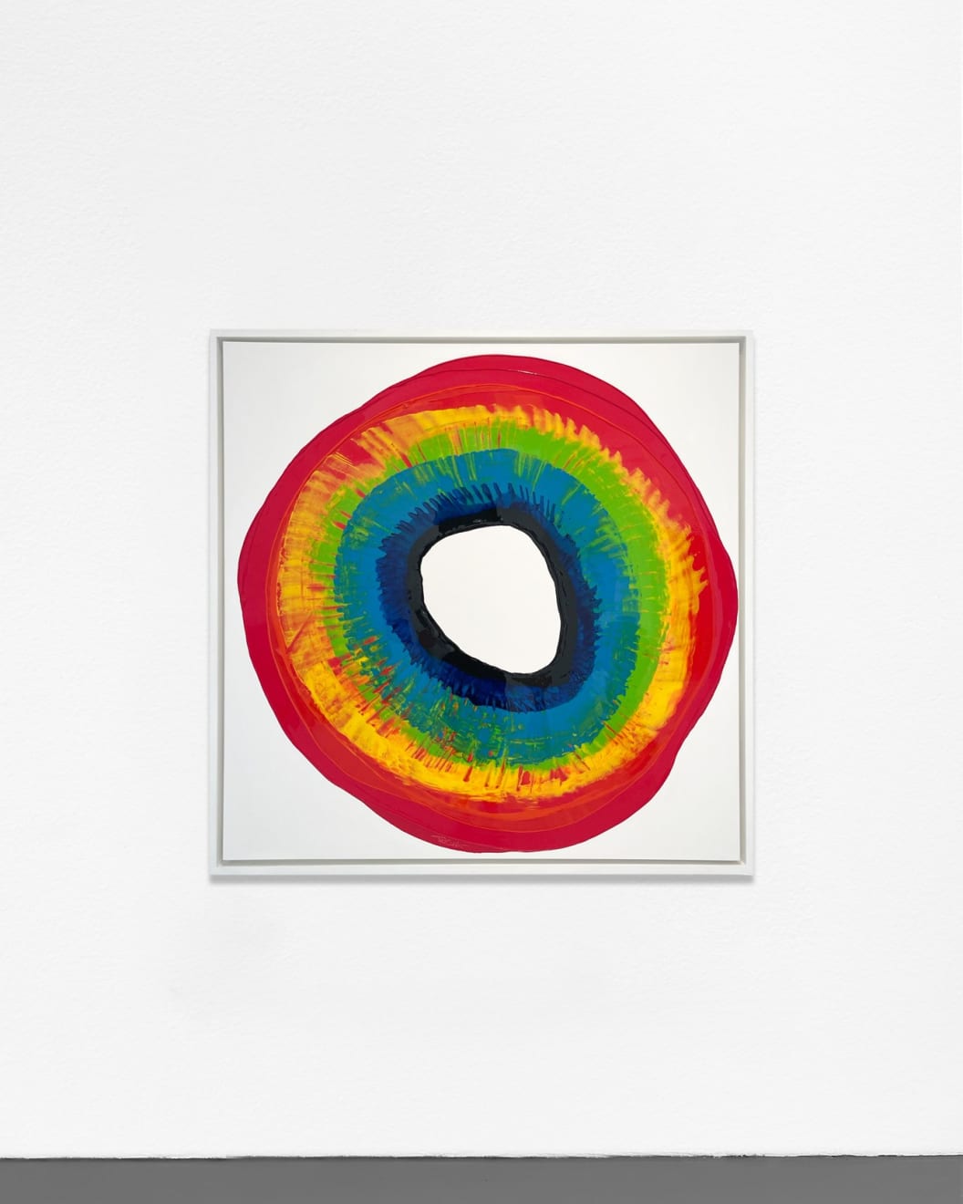 Ted Collier Circle series painting with rainbow tie dye circle on white canvas hanging on a white wall