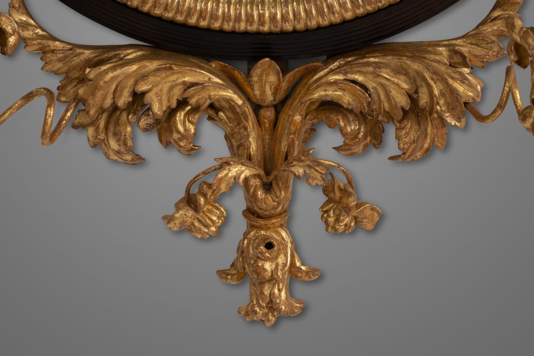 Regency carved giltwood and ebony convex mirror with griffin crest