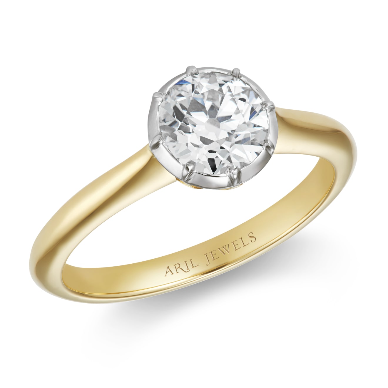 Solitaire old cut diamond ring set in a cutdown setting of platinum with an 18ct yellow gold band on a white background