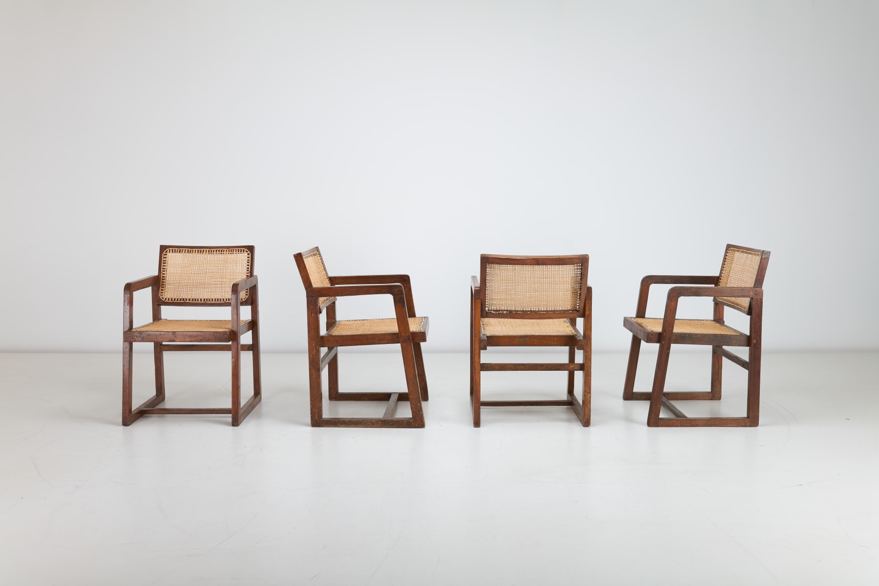 Multi angled Pierre Jeanneret Box Armchair with square-legs, crafted in teak and cane