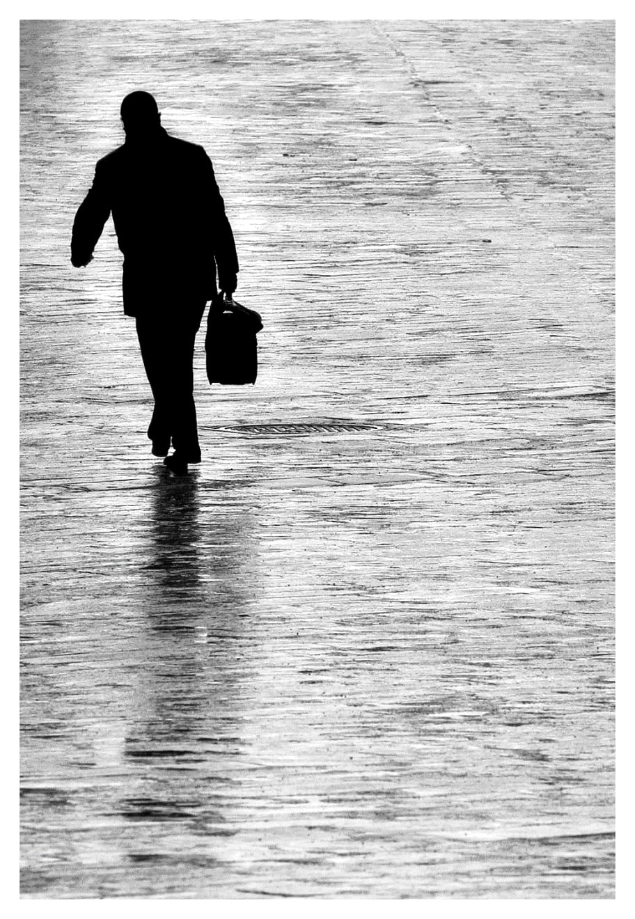 Black and white silhouette photograph of a business man in Bologna, Italy.