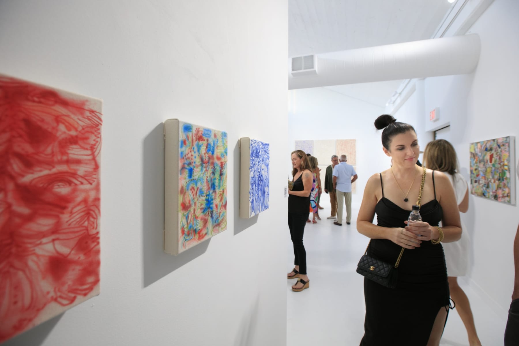 Guests at the opening reception of "Tiger Moth", a solo exhibition by Sarah Giannobile. Photo by Suzy Gorman