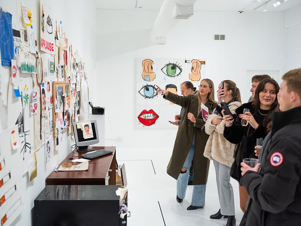 Guests at Sage Barnes's "Employee Of The Month" opening reception