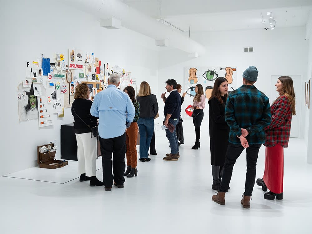 Guests at Sage Barnes's "Employee Of The Month" opening reception