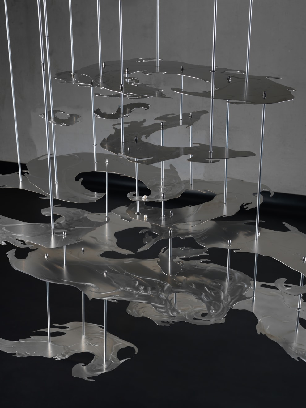 Elli Antoniou, Proximal Volution, 2025, Aluminium slab, Stainless steel sheets, stainless steel threaded rods, chains, fixings (washers, domenuts, connectors, carabiner clips, adjustable hooks), aluminium tubes, pearls, 300 x 150 x 70 cm