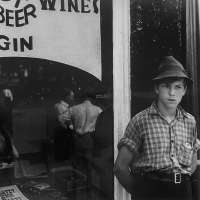 Boy in front of liquor store, Newark, Ohio
